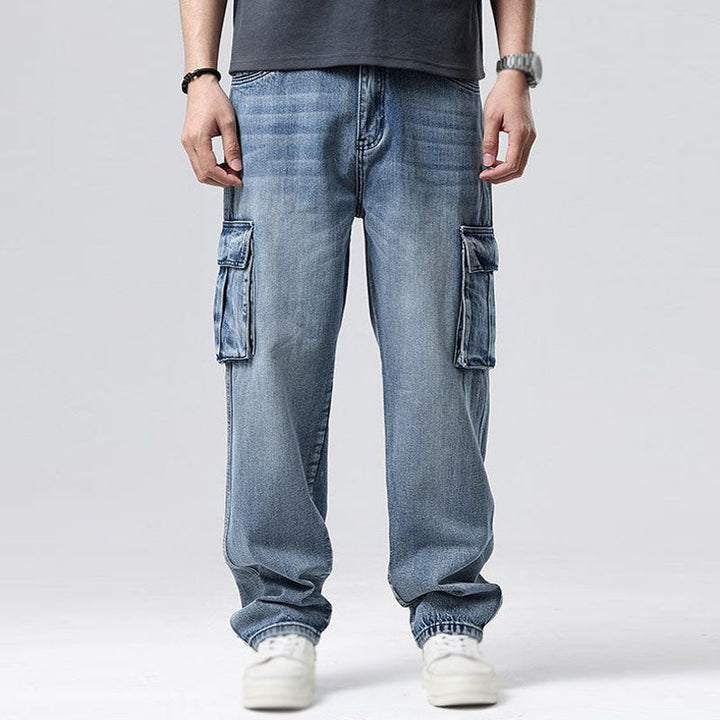 Mens utility cargo jeans, durable blue denim with multiple practical pockets for urban & casual style.