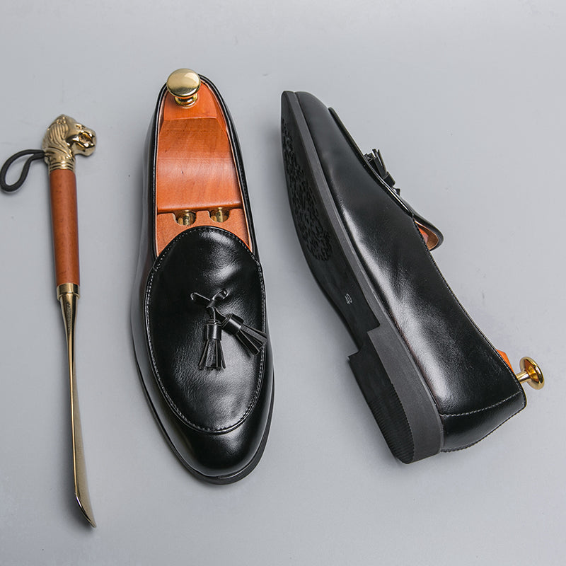 Close-up of men's tasseled slip-on loafers showing detailed stitching and elegant tassels.