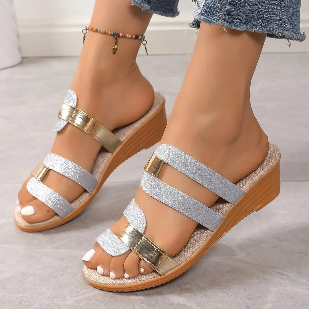 Shimmering women's strappy sandals, perfect for a chic evening outfit.