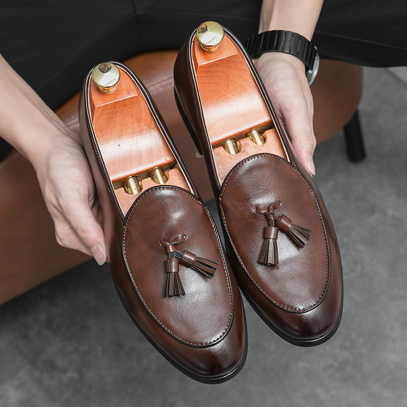 Black men's tasseled slip-on loafers, sophisticated dress shoes for work and events.