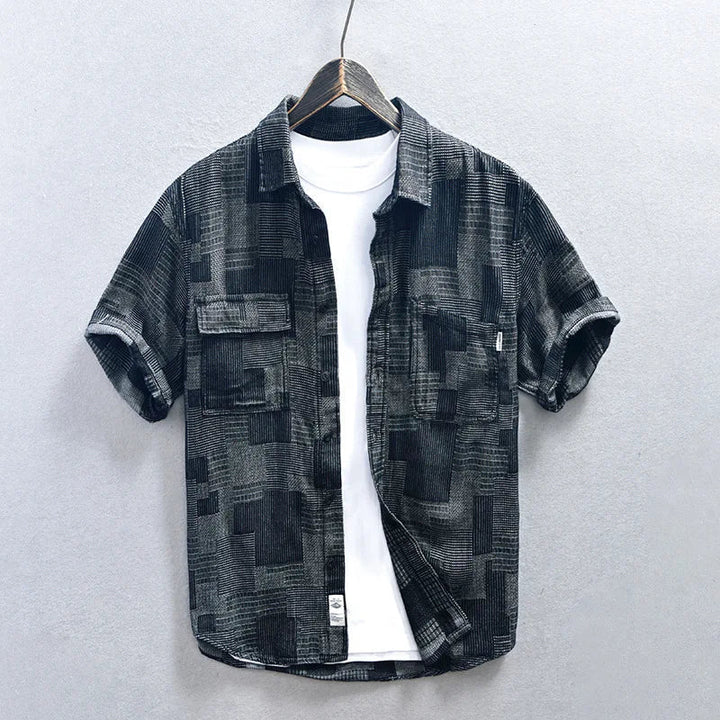 Blue men's button-down shirt featuring multiple pockets & long sleeves. A comfortable & stylish casual top.