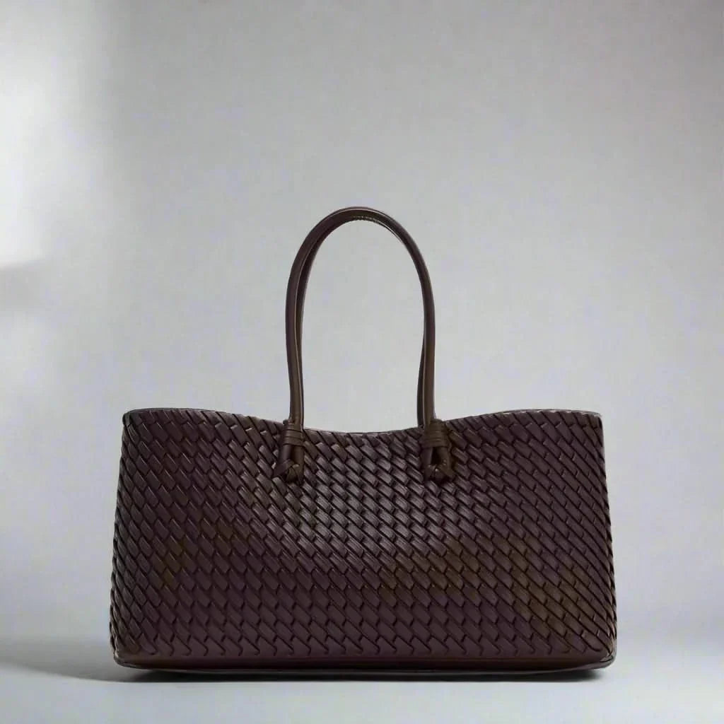 Elegant women's woven leather handbag with intricate design, perfect for everyday carry.