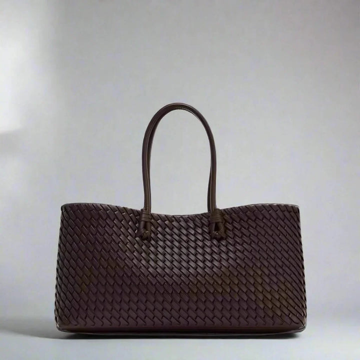 Elegant women's woven leather handbag with intricate design, perfect for everyday carry.