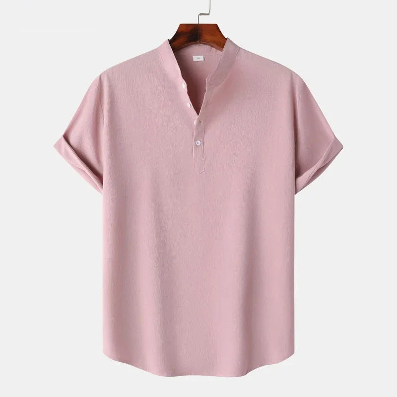 Folded men's natural tone henley top, a comfortable classic long sleeve shirt for casual occasions.