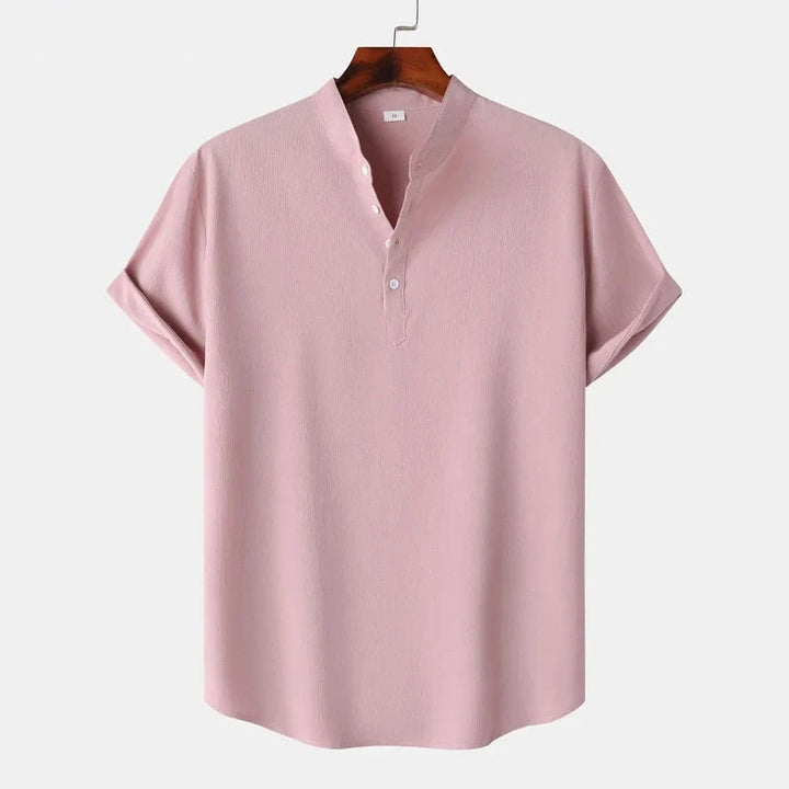 Folded men's natural tone henley top, a comfortable classic long sleeve shirt for casual occasions.