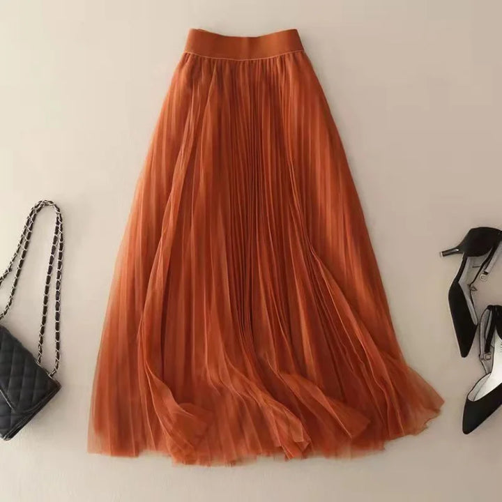 Versatile women's high-waist pleated A-line flowy skirt, midi length, suitable for elegant or casual spring outfits.