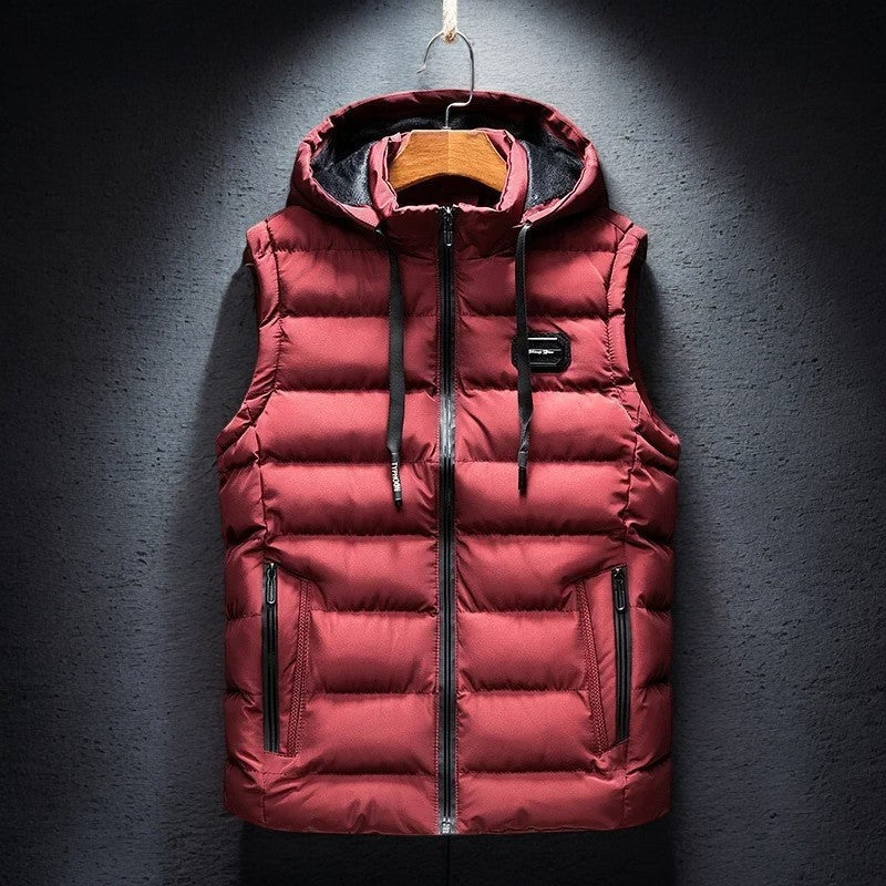Men's Midtown hooded puffer vest, insulated for warmth. Ideal lightweight outerwear for fall & winter travel.