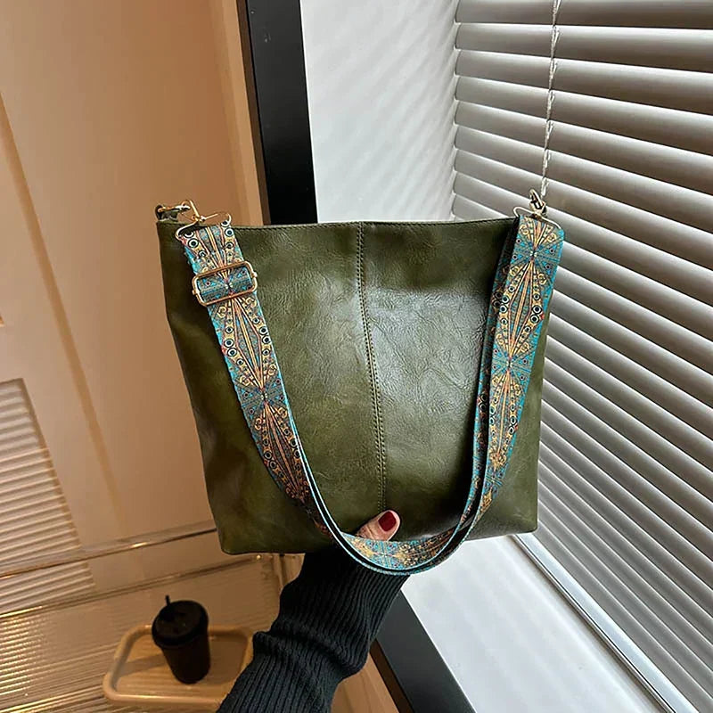 Stylish women's shoulder bag, bohemian design, durable synthetic leather, & a unique patterned strap.