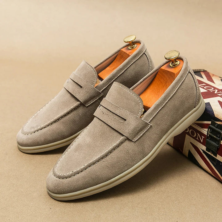 Black Milan slip-on loafers for men, ideal as versatile dress shoes or smart casual footwear.