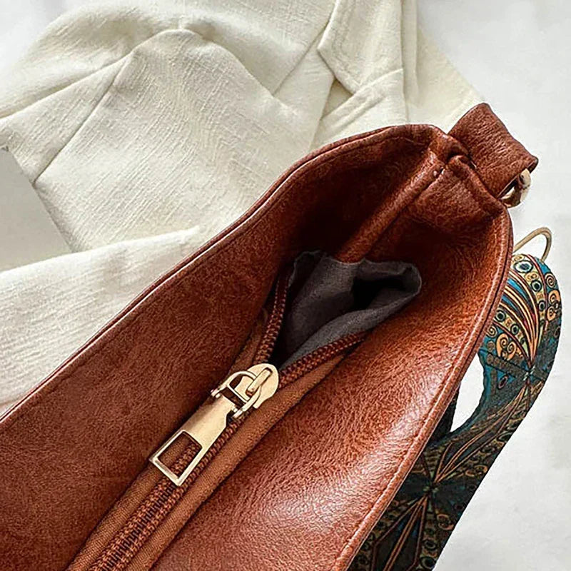Women's fashion shoulder bag: bohemian aesthetic, synthetic leather, and a vibrant patterned guitar strap.