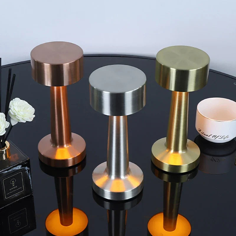 Compact portable LED lamp with touch control, features USB charging for convenient use.