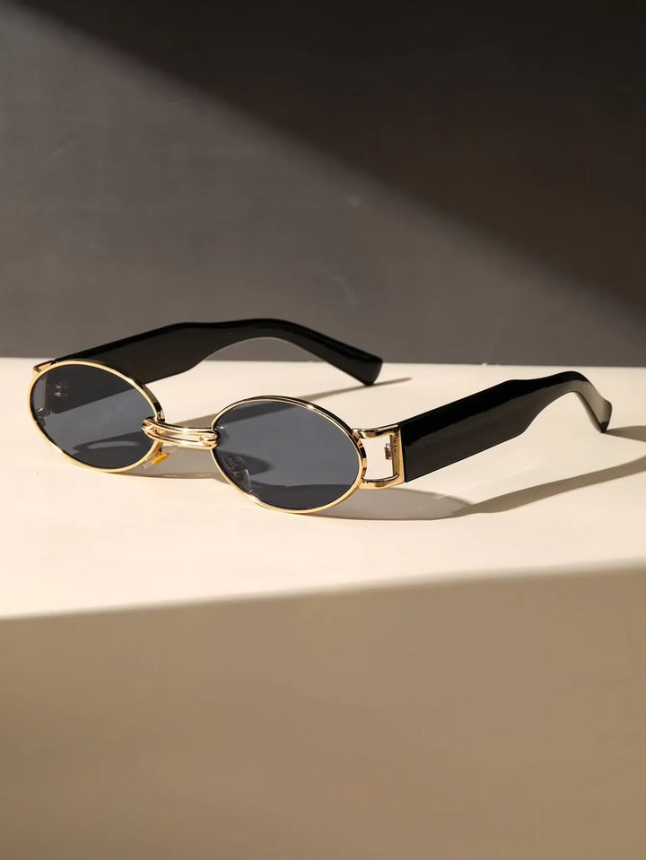 Chic women's oval sunglasses, UV400 for eye protection. Features stylish gold accents and black temples. Fashion accessory.