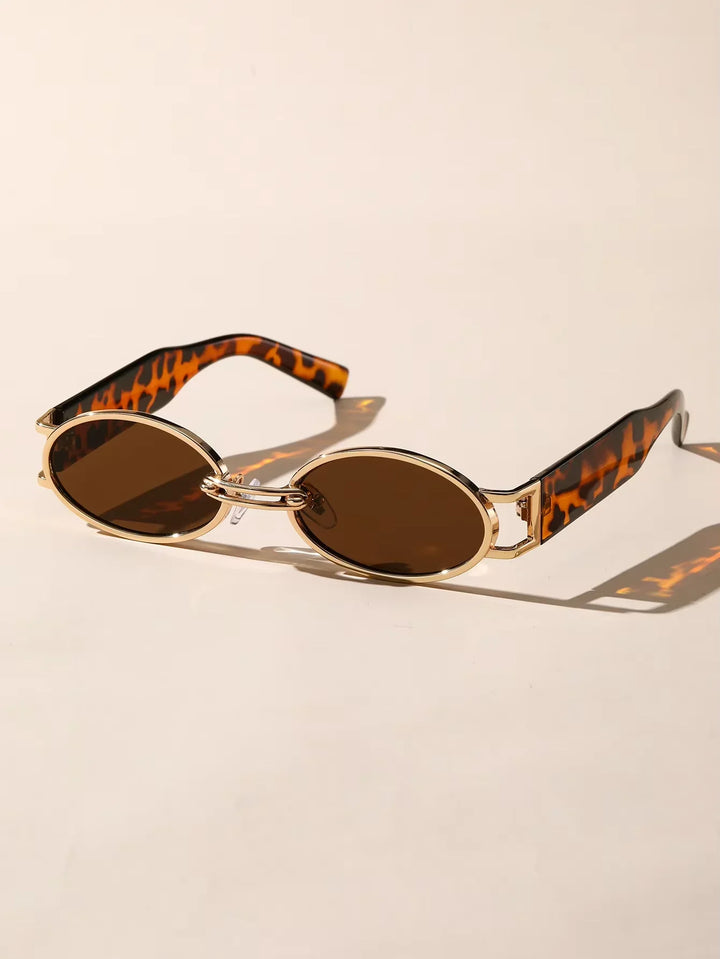 Stylish women's oval sunglasses with UV400 protection, black temples & elegant gold accents. Perfect eye protection.