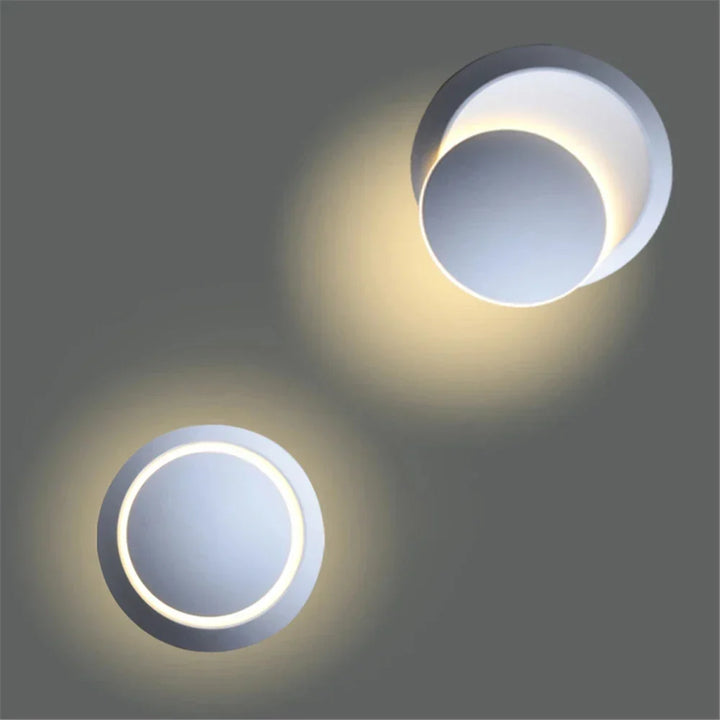 Minimalist white adjustable LED wall lamp, modern decor, provides focused light for home or office.