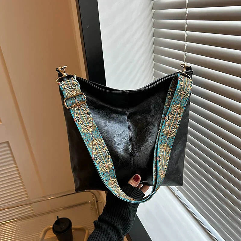 Women's synthetic leather shoulder bag, bohemian style with an adjustable patterned strap.