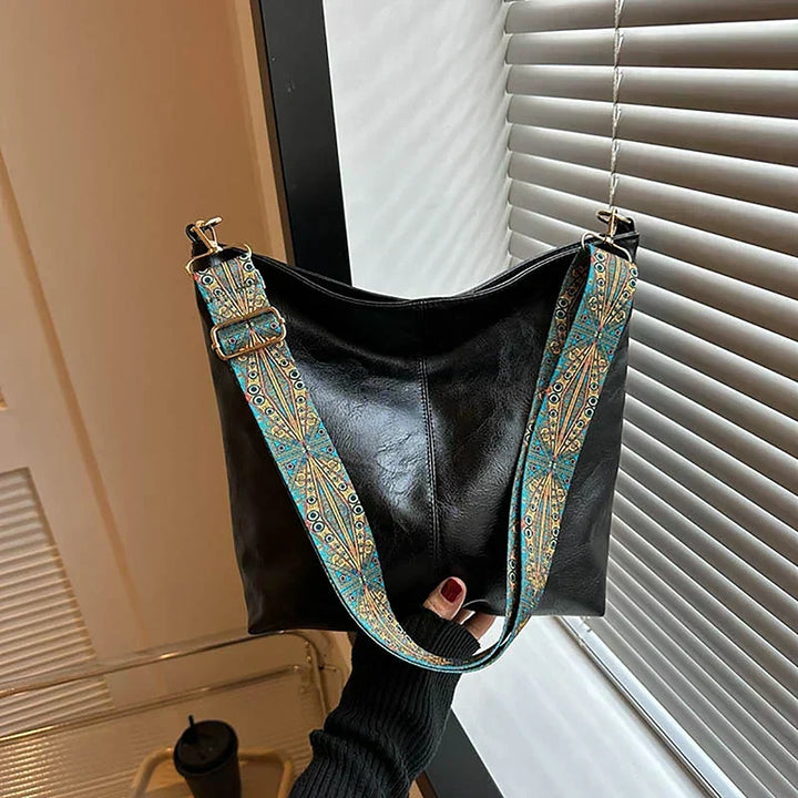Women's synthetic leather shoulder bag, bohemian style with an adjustable patterned strap.