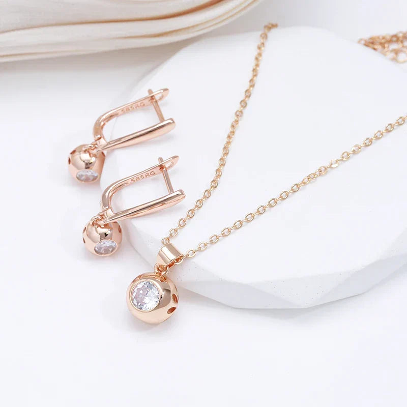 Model wearing an elegant women's rose gold zircon orb necklace and earrings jewelry set.