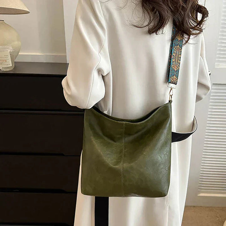 Stylish slouchy bohemian shoulder bag for women, featuring a vibrant patterned guitar strap.