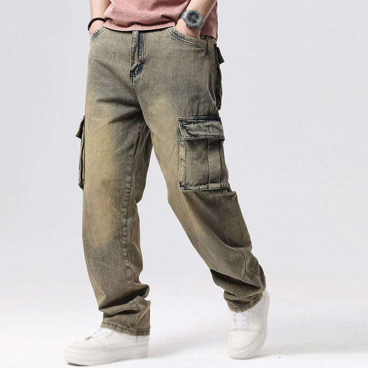 Close-up of a large side cargo pocket on men's blue utility jeans, highlighting storage & detail.