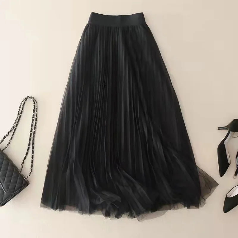 Casual elegant women's pleated A-line flowy midi skirt, high-waisted, versatile for warm weather spring outfits.