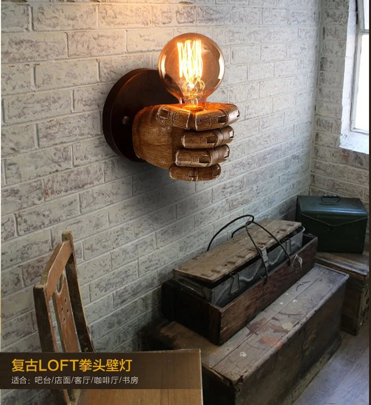 Commercial-grade sculpted fist wall light. Unique artistic resin sconce for impactful business lighting.