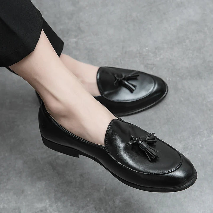 Full view of men's brown tasseled loafers, stylish and versatile for various outfits.