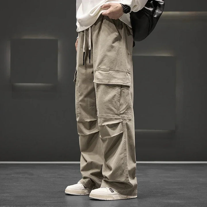 Men's green relaxed fit utility cargo pants with drawstring waist, offering comfort for casual wear.