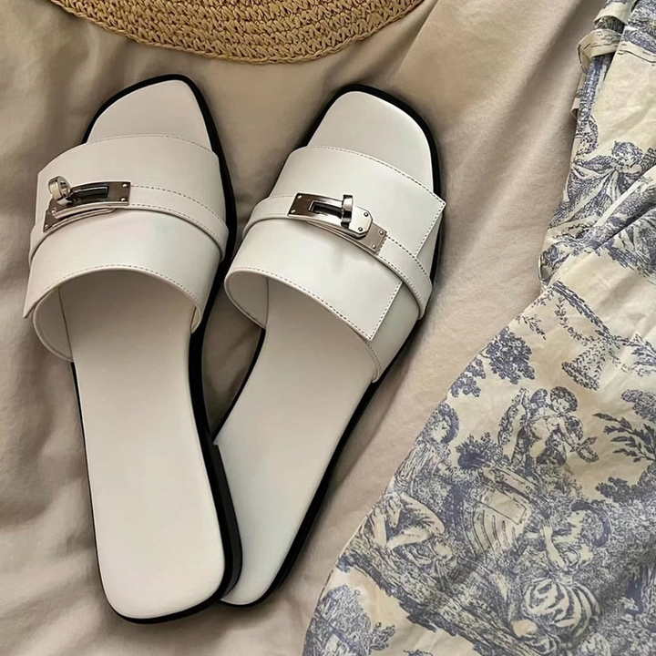 Chic women's square-toe leather slides with metallic buckle. Elegant and comfortable slip-on summer sandals.