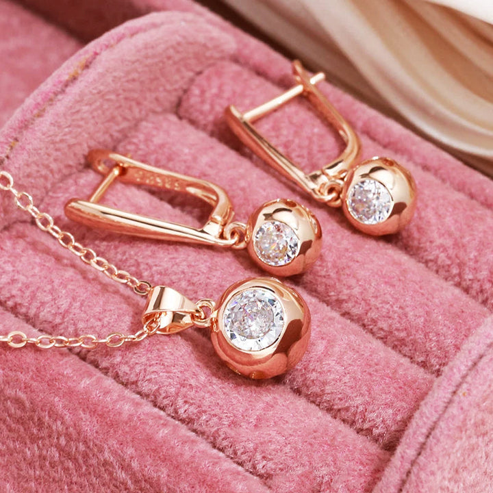 Elegant women's rose gold zircon orb jewelry set with matching earrings and necklace, perfect for gifts.