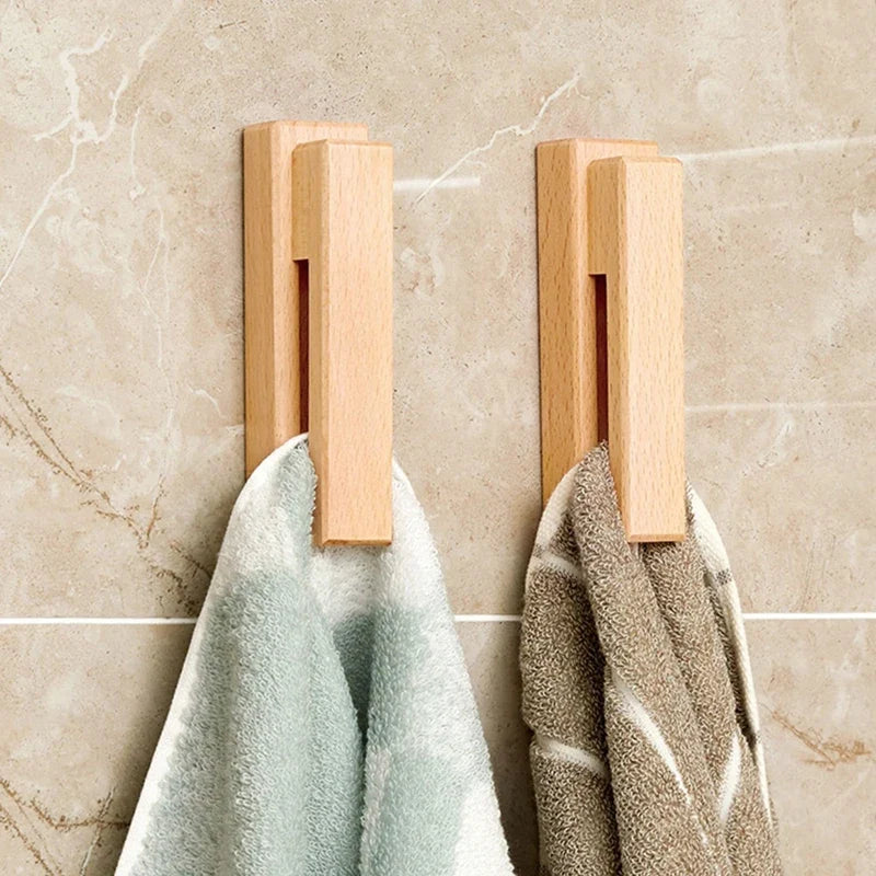 Adhesive wooden wall hook for towels, crafted from natural beech wood. Perfect no-drill solution for bathrooms.