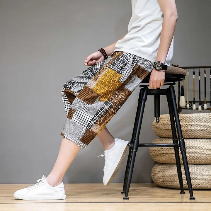 Front view: Man in men's unique patch capris shorts, showcasing comfortable fit and unique style for casual summer wear.
