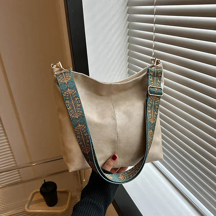 Bohemian slouchy bag for women, featuring a stylish patterned guitar strap. Great everyday accessory.