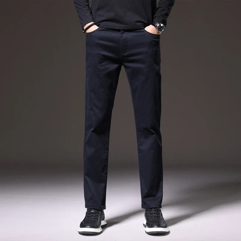 Men's versatile khaki cotton chino trousers paired with a classic shirt, creating a comfortable smart-casual look.