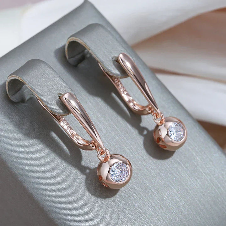 Close-up of rose gold zircon orb pendant necklace for women, part of an elegant jewelry set.
