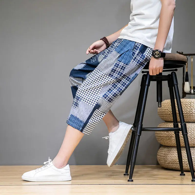 Side view of men's unique patch capris shorts, demonstrating capri length and bold streetwear aesthetic for men.