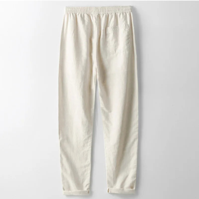 Relaxed fit unisex linen trousers in classic beige, offering breathable comfort for everyday casual summer style.
