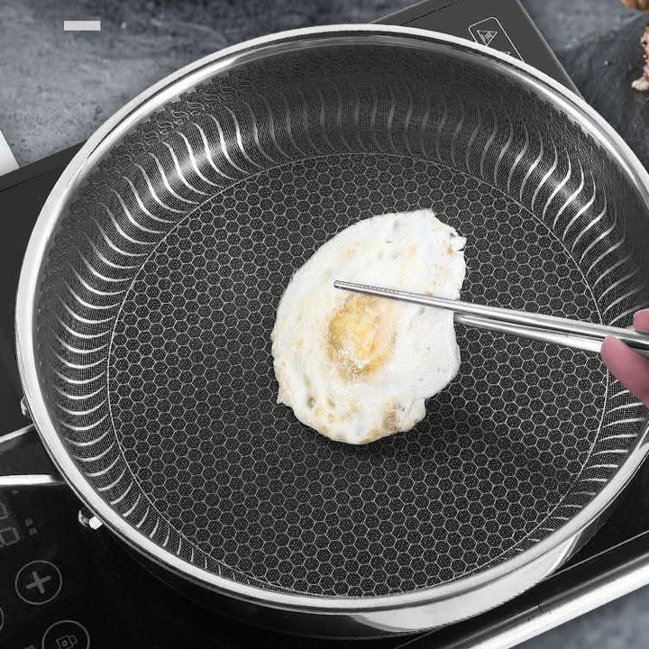 Heavy-duty stainless steel frying pan designed for even cooking. Professional-grade, oven-safe and induction ready.