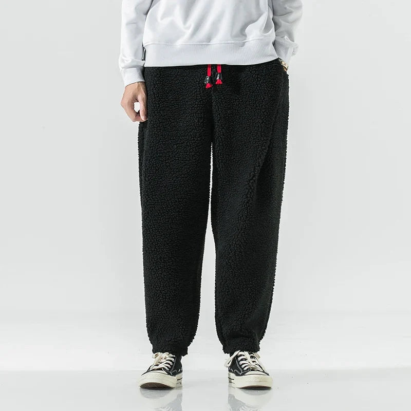 Man wearing comfortable men's sherpa joggers, perfect for a relaxed fit and cozy loungewear. Casual & stylish.