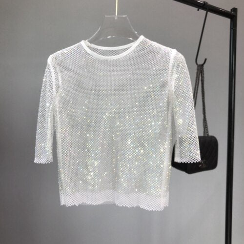 Shimmering women's sparkle t-shirt, dazzling with sequins for a glamorous party top. Perfect festive evening wear.
