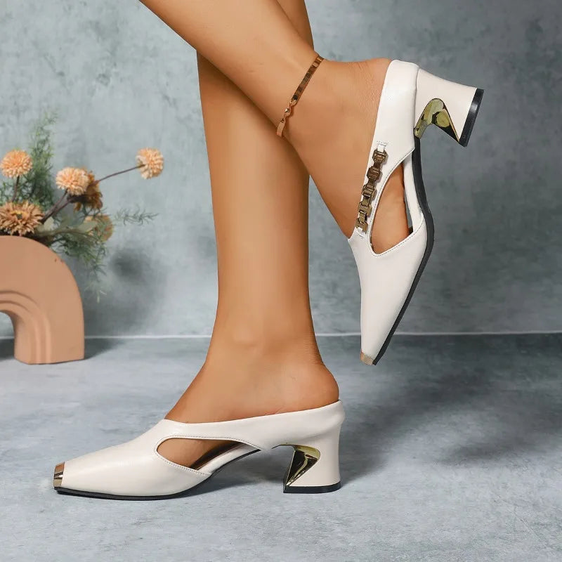 Women's sophisticated pointed high heels with polished gold metal toe accent.