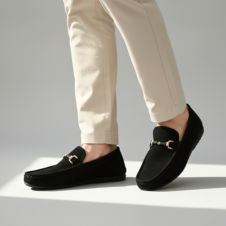 Polished men's slip-on loafers with a sophisticated buckle, ideal for a refined office or evening style.