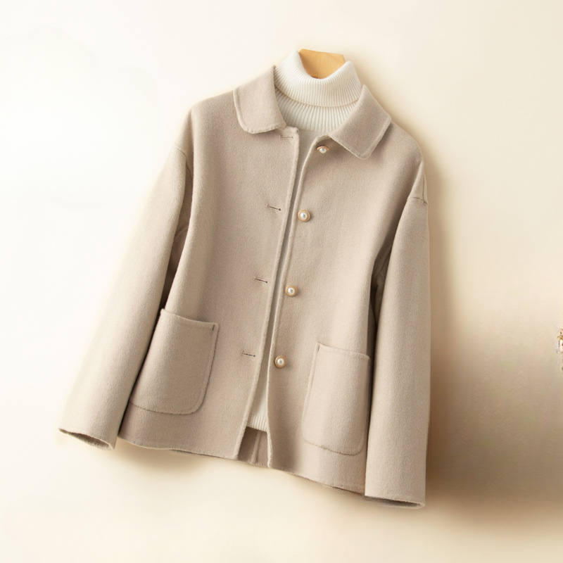 Women's elegant cropped coat with a distinctive doll collar, a sophisticated long sleeve jacket for autumn style.