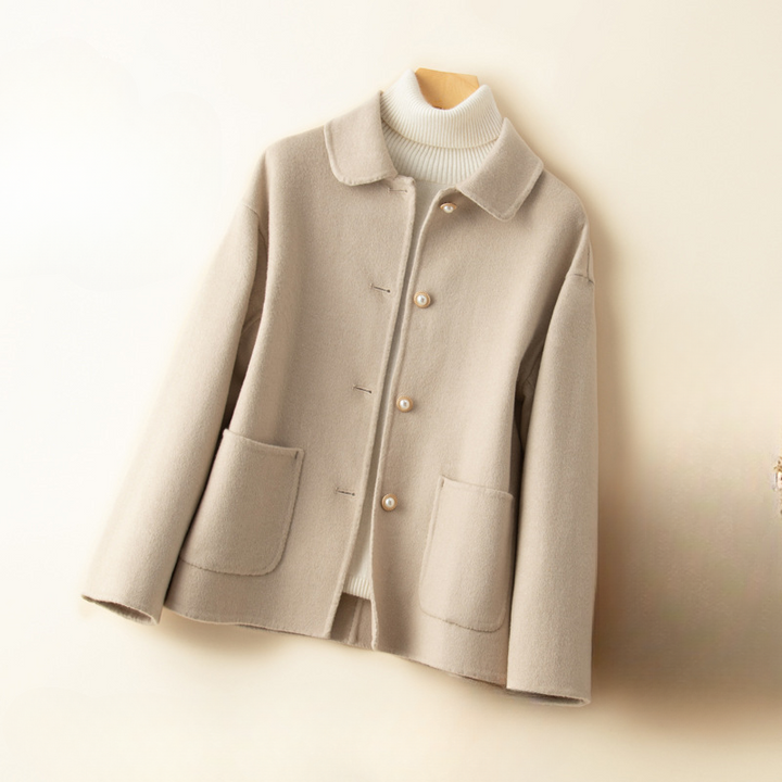 Women's elegant cropped coat with a distinctive doll collar, a sophisticated long sleeve jacket for autumn style.