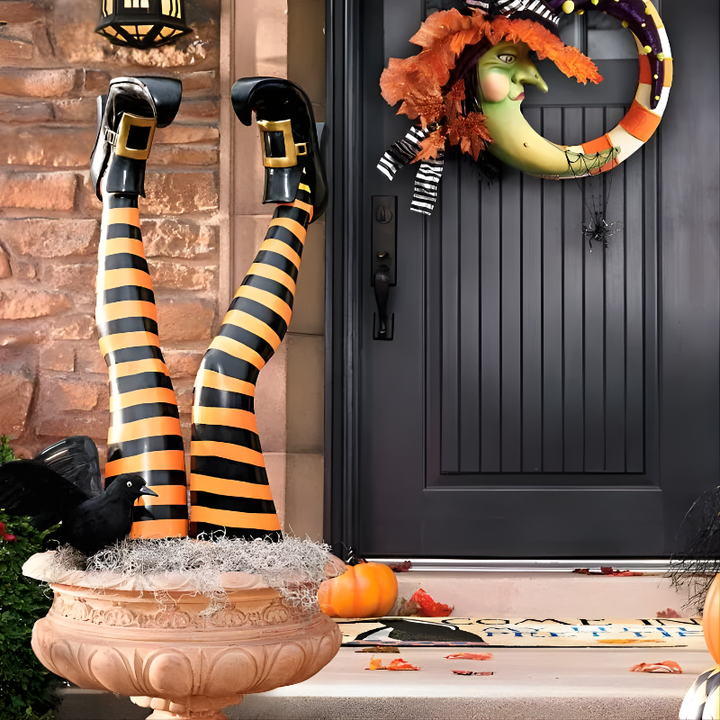 Set of 2 Halloween witch leg yard stakes in purple and orange stripes, perfect for spooky outdoor lawn decoration.