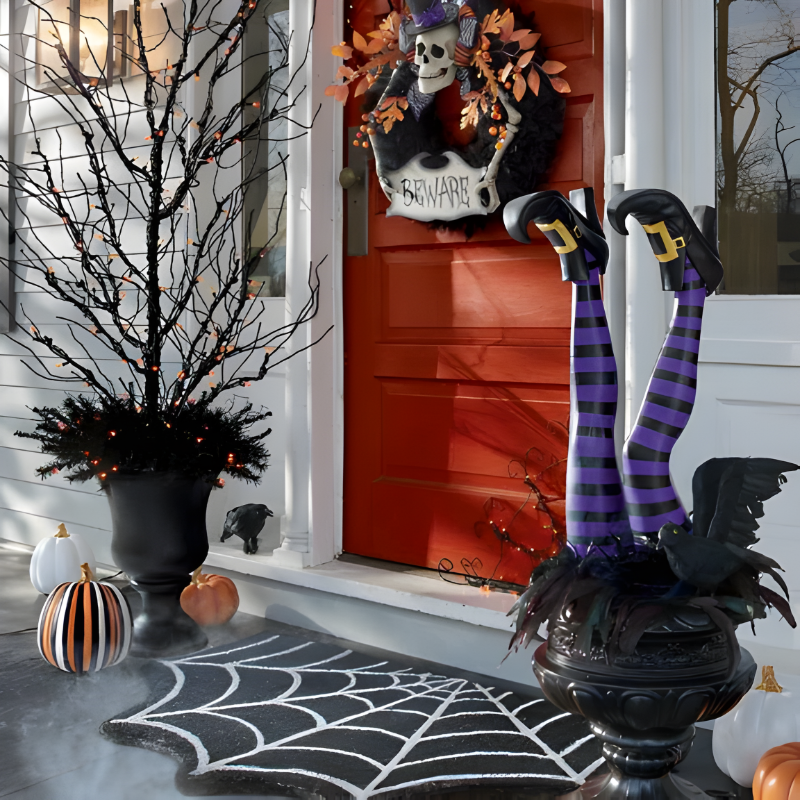 Comical pair of witch leg yard stakes, featuring striped stockings and black boots, sticking out of a lawn.