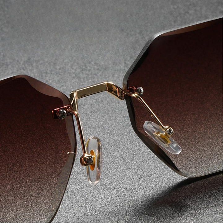 Lightweight unisex rimless octagonal sunglasses with a minimalist metal frame, offering comfortable fashion eyewear.
