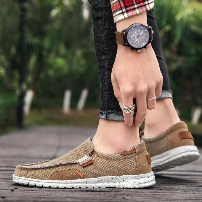 Man wearing comfortable Dockstone khaki slip-on canvas shoes, perfect for casual everyday walking.