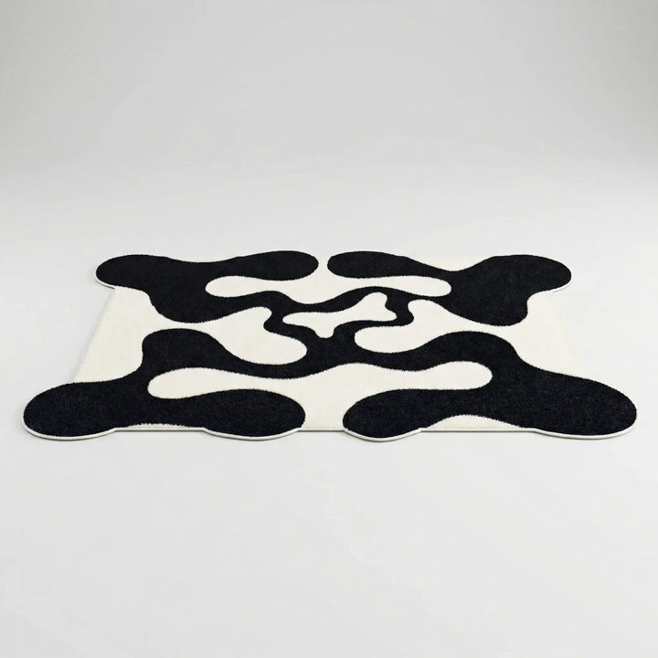 Flowique statement area rug with a captivating abstract wave pattern, perfect for contemporary home decor and living spaces.