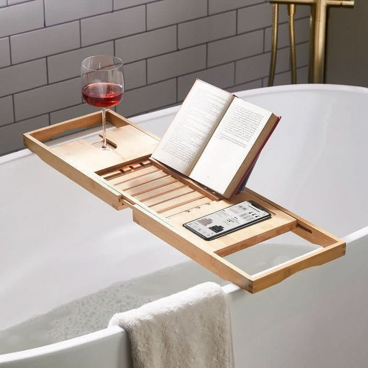 Adjustable bamboo bathtub caddy for relaxing spa baths. Eco-friendly bath tray for books, wine & accessories.
