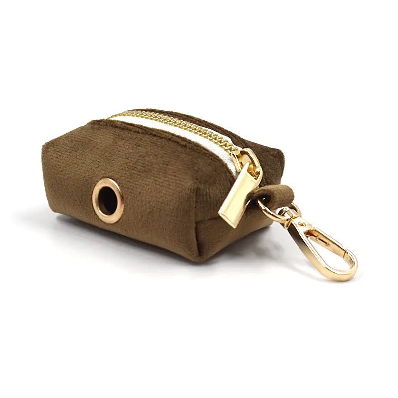 Close-up of a high-quality adjustable suede dog collar in brown, with a discreet poop bag attachment